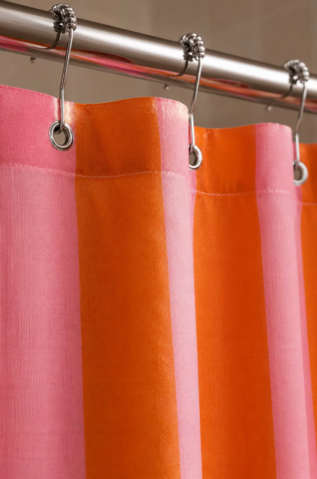 Graphic striped shower curtain shown in a bright bathroom
