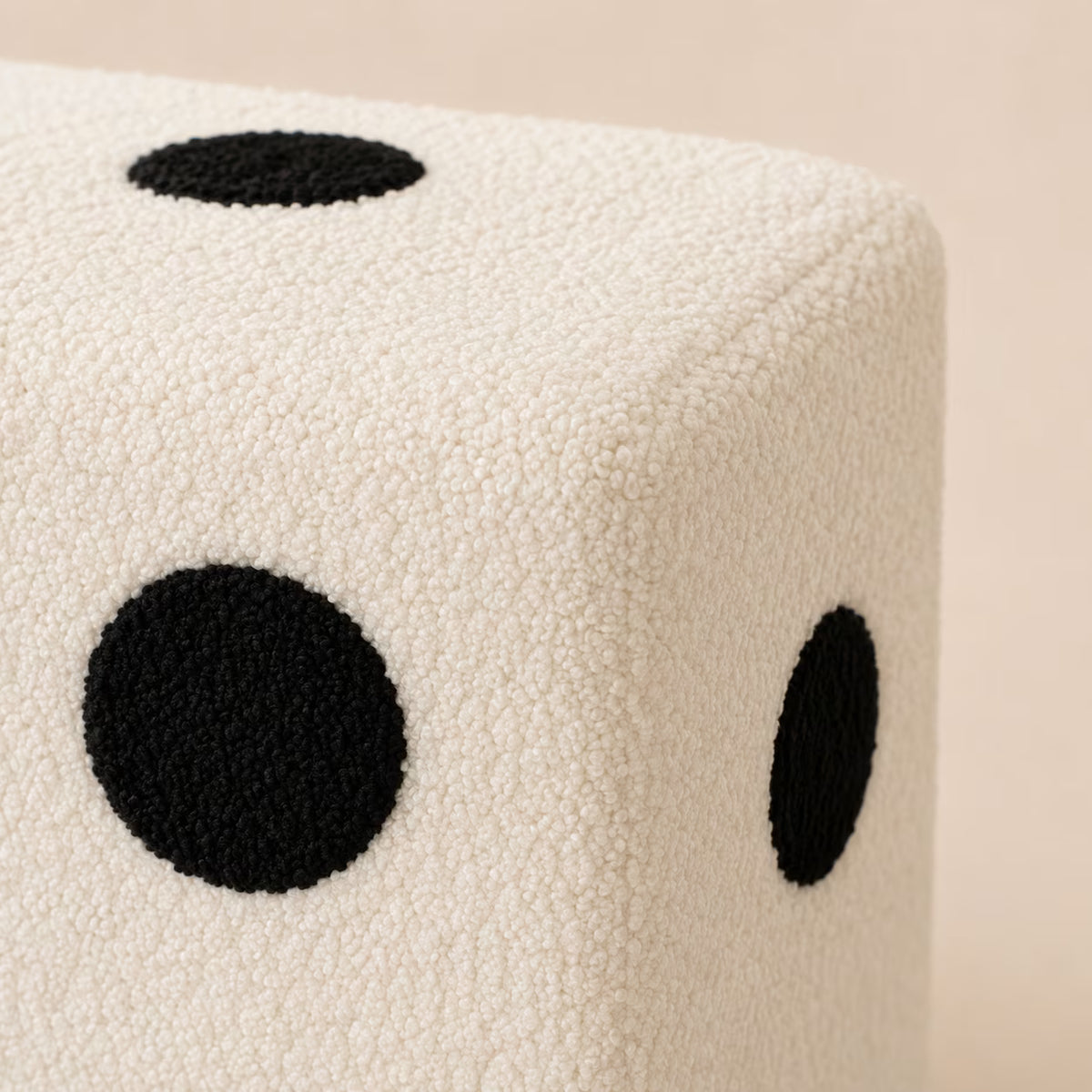 Close-up of the White Dice Footstool’s textured upholstery