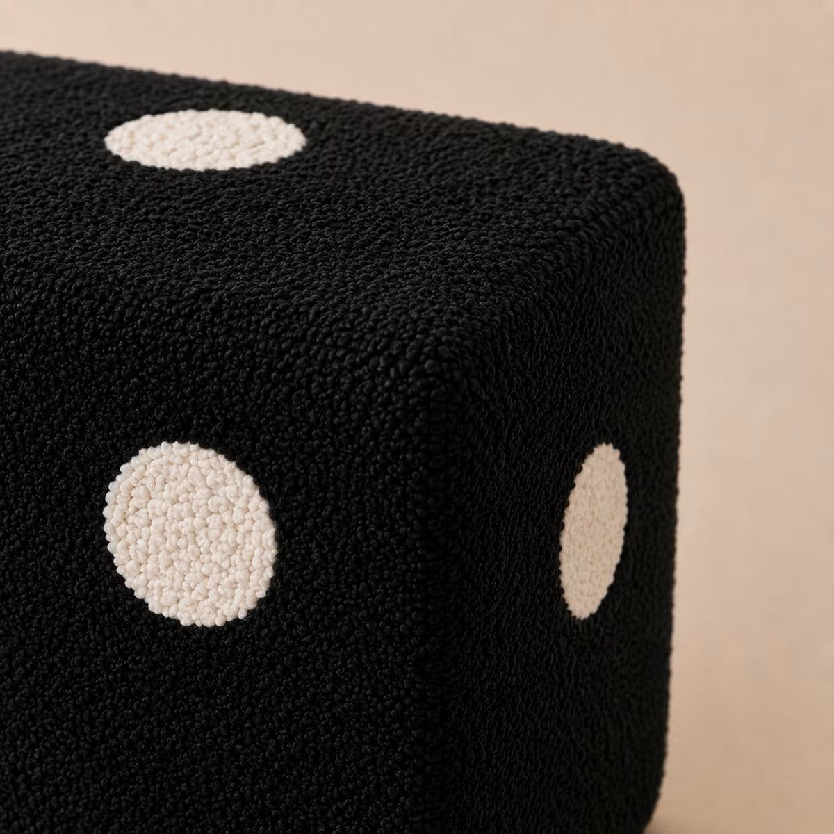 Close-up of the Black Dice Footstool’s textured upholstery