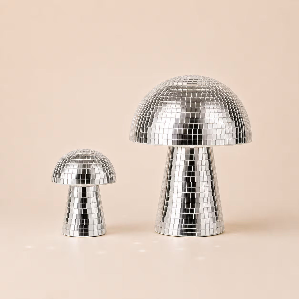 Three silver Disco Mushrooms covered in reflective mirrored sequins