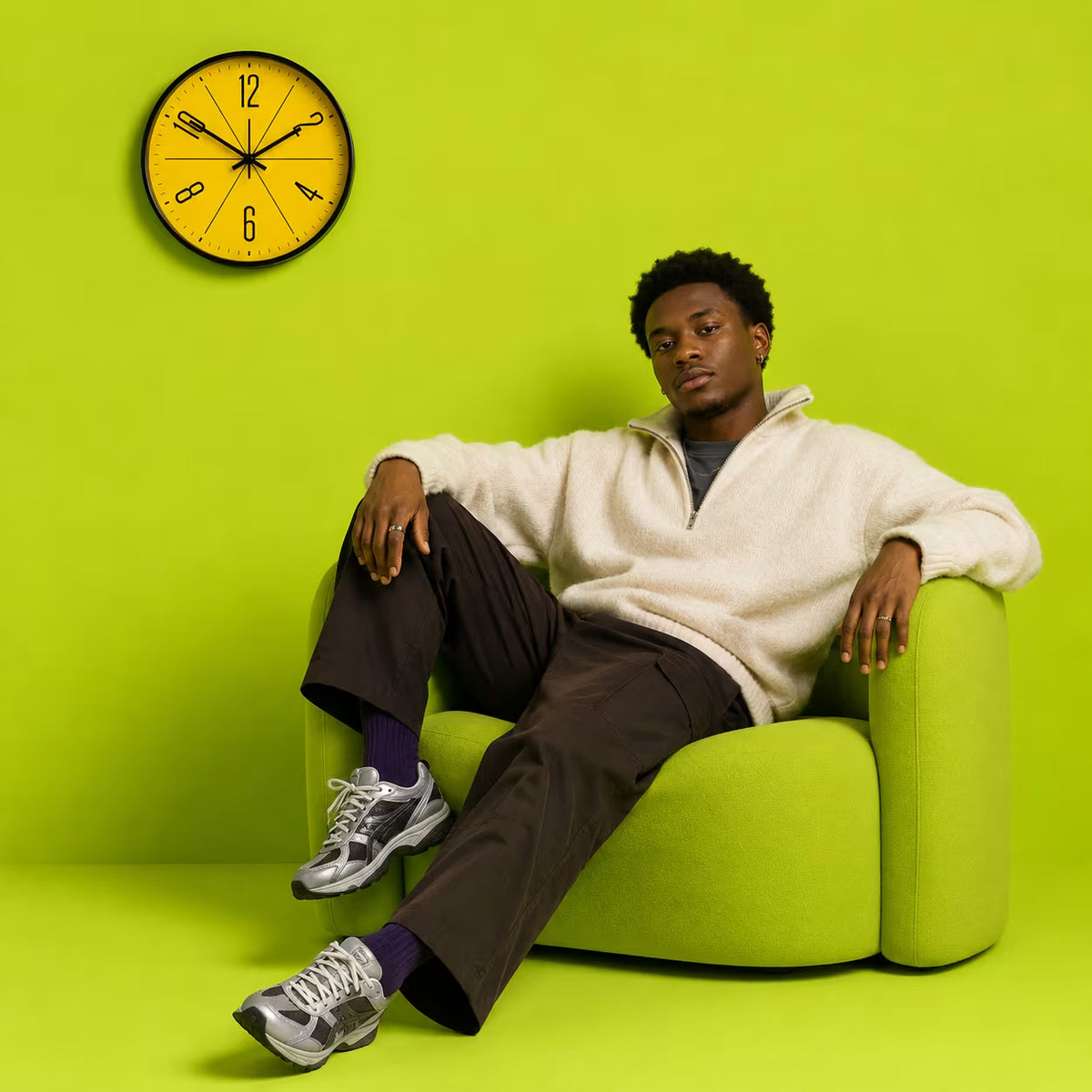 Yellow Modern Nordic Wall Clock styled above a green armchair