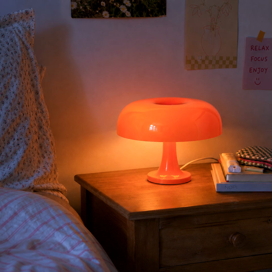 Orange mushroom table lamp adding warm colour to a styled living room