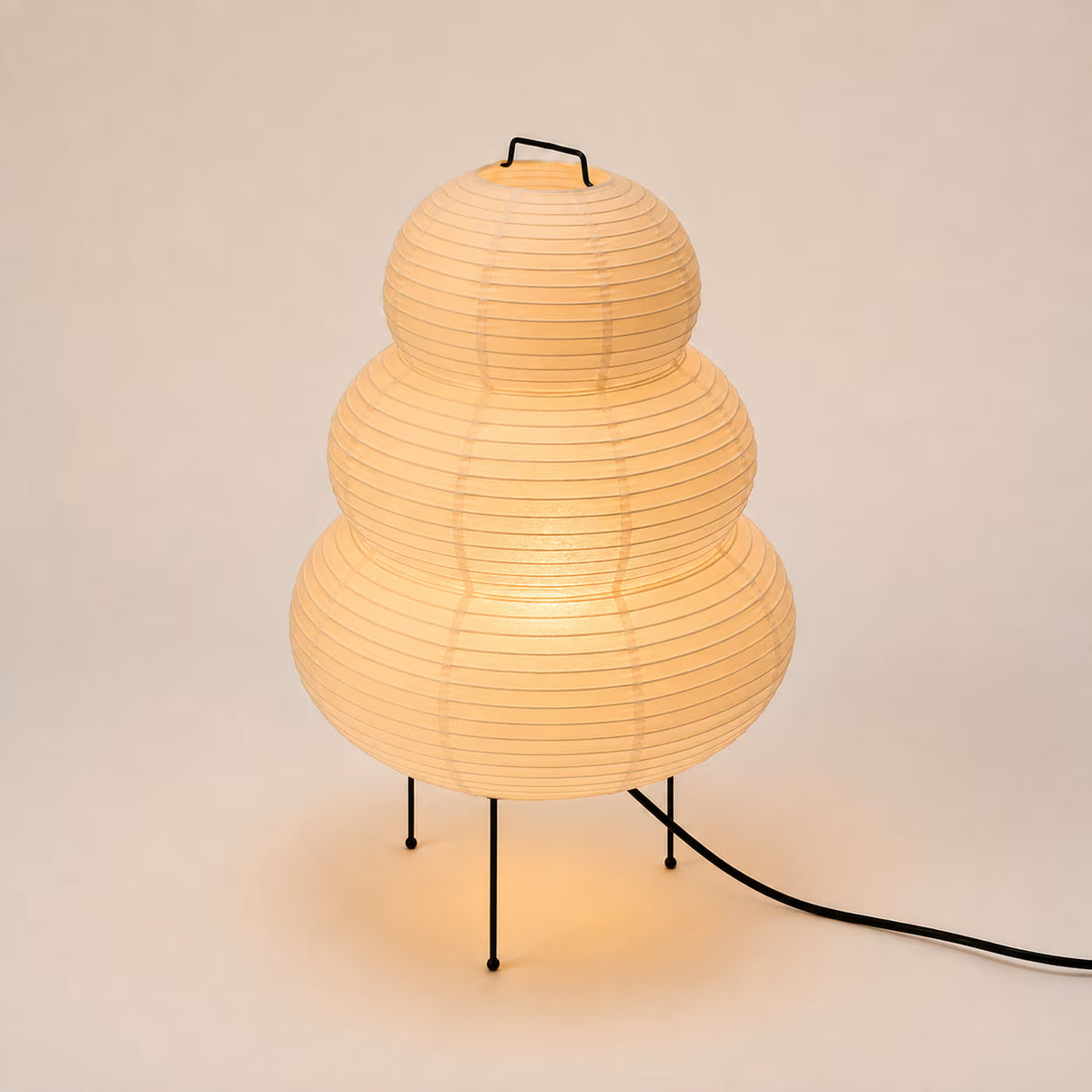 Ribbed Japanese rice-paper lamp producing a softly diffused glow