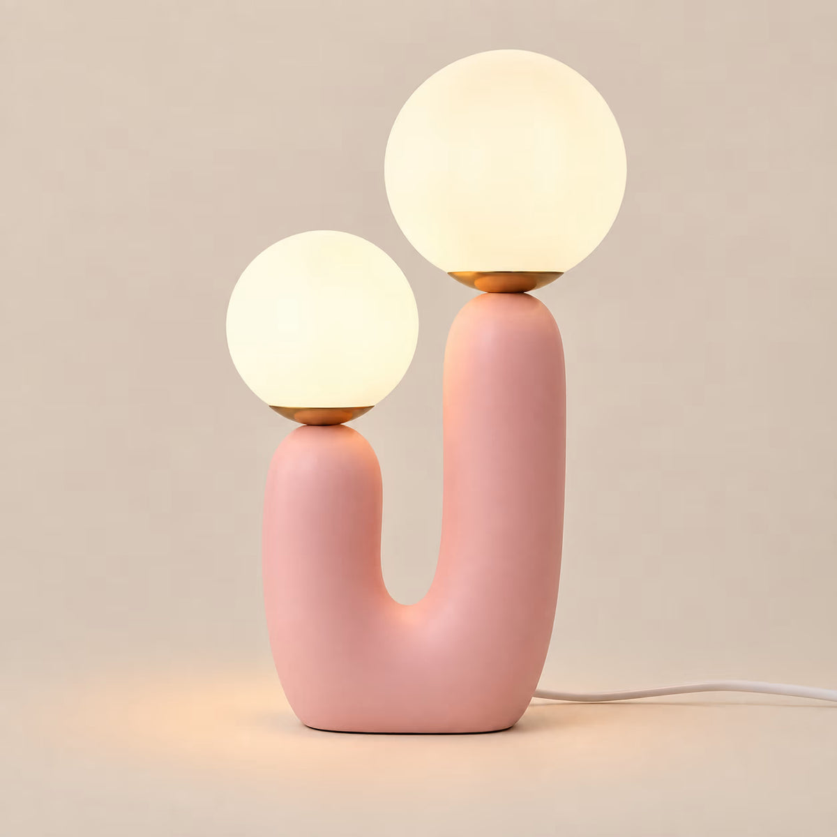Pink Cacti table lamp with two illuminated glass globes at different heights