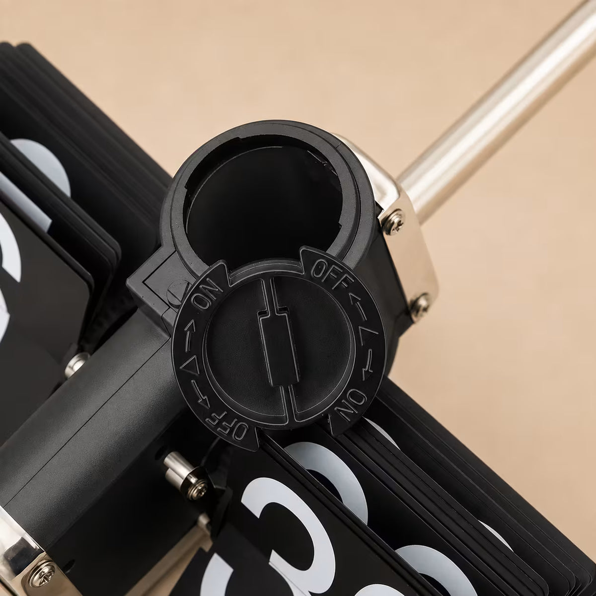 Side view showing the polished steel base and rotating number-card mechanism