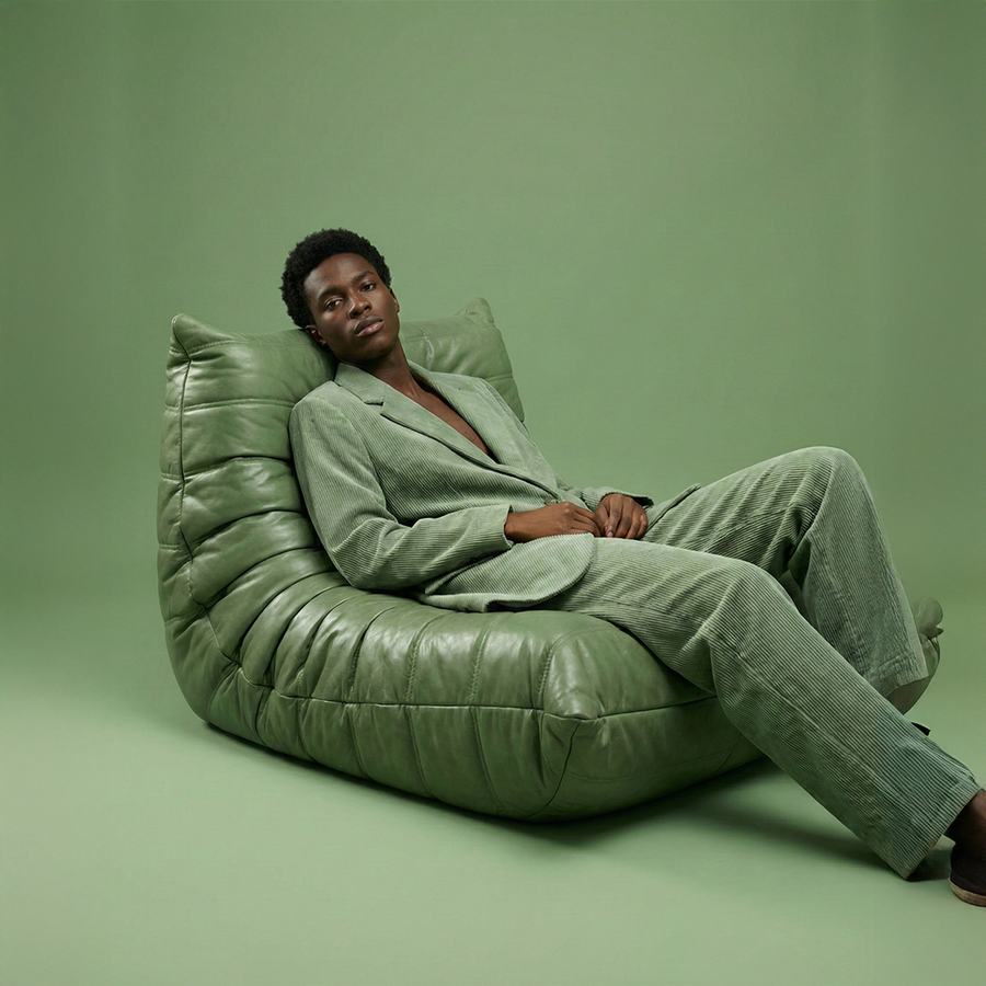 Green Caterpillar Lounger Chair anchoring a styled living-room corner
