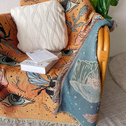 Orange woven throw styled across interior furniture