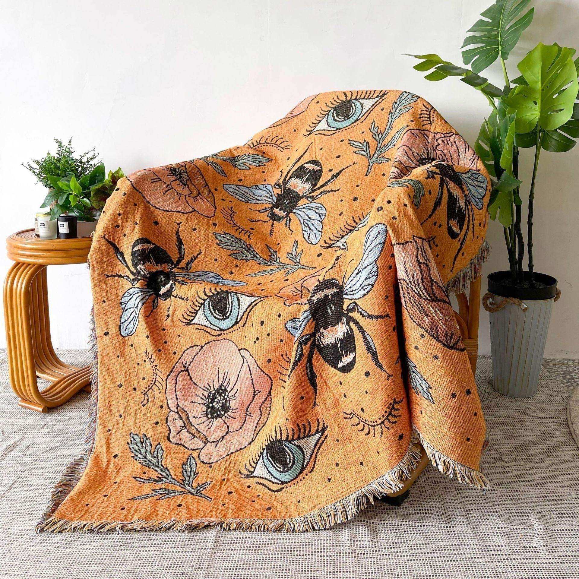 Bumble Bee woven tapestry throw with orange botanical artwork
