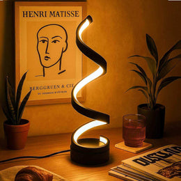 Black spiral LED table lamp with sculptural light curve