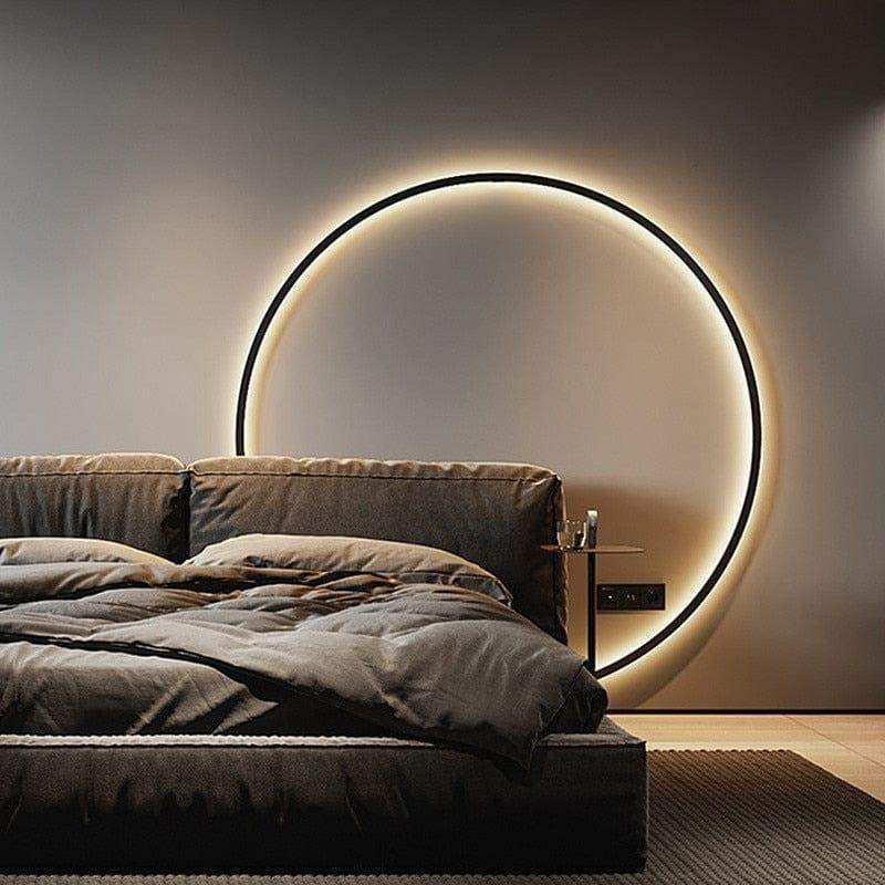 Minimalist LED ring wall light in black with a soft circular glow