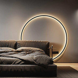 Minimalist LED ring wall light in black with a soft circular glow