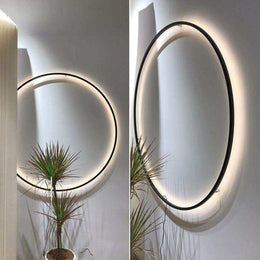 Circular LED wall light showing its slim aluminium frame