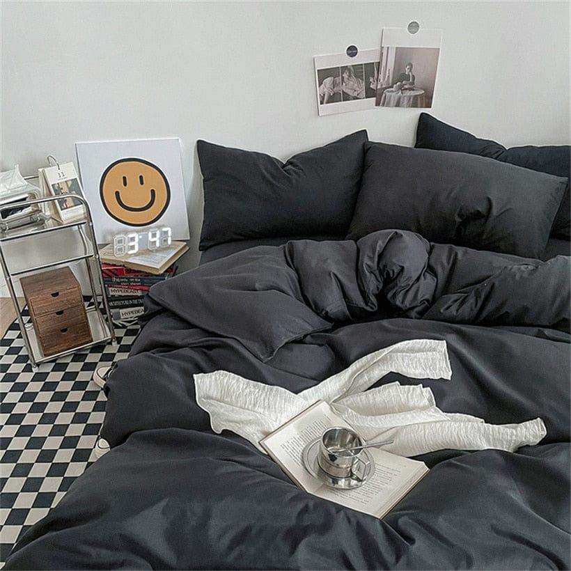 Solid black Noir bedding set styled on a bed